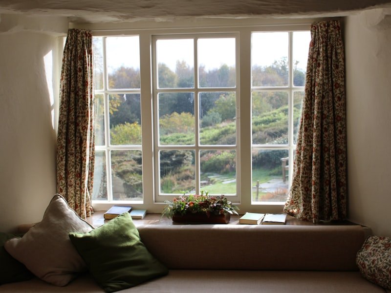 Warm home interior with a wide window and open curtains